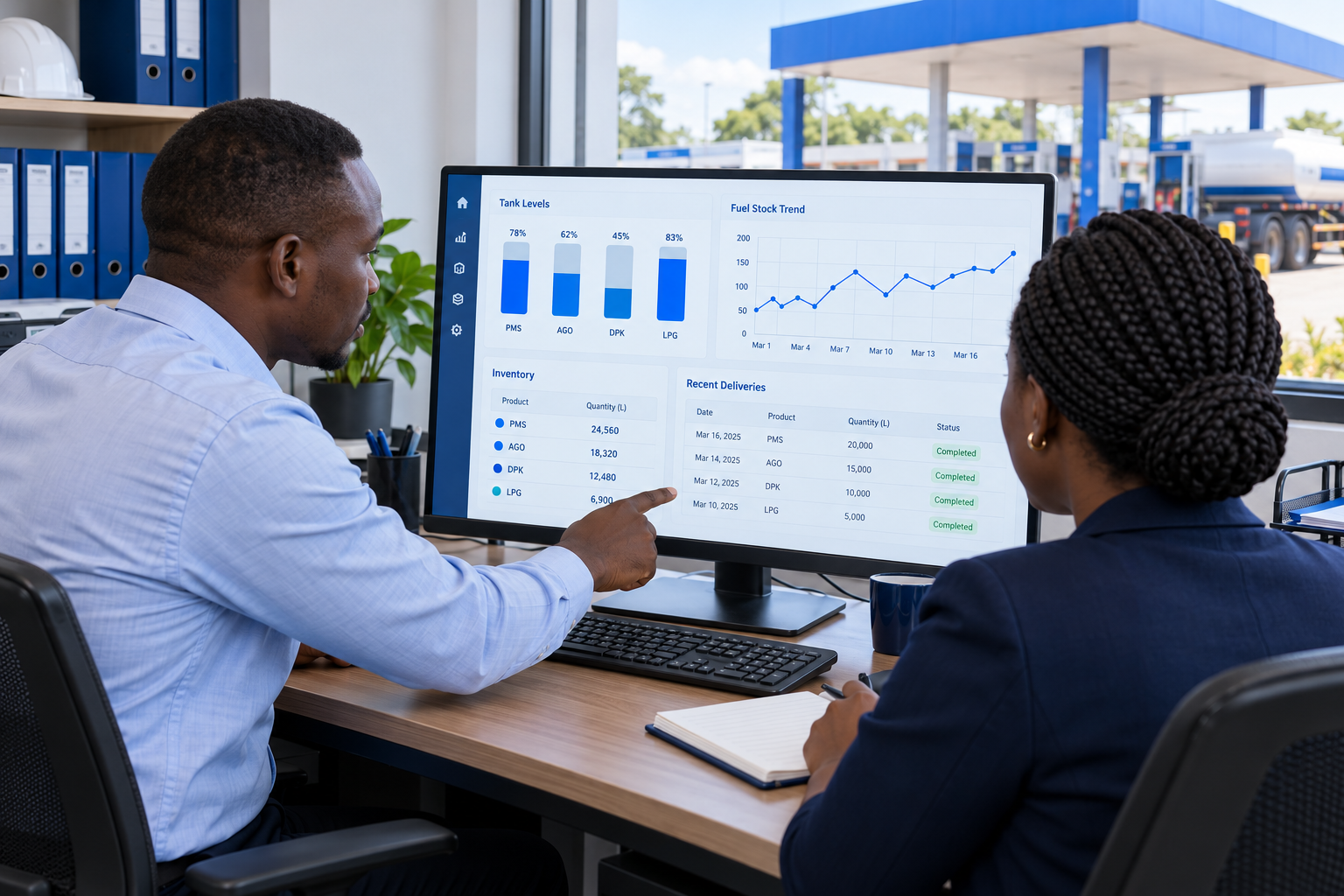 Office staff reviewing fuel stock levels on a desktop application.